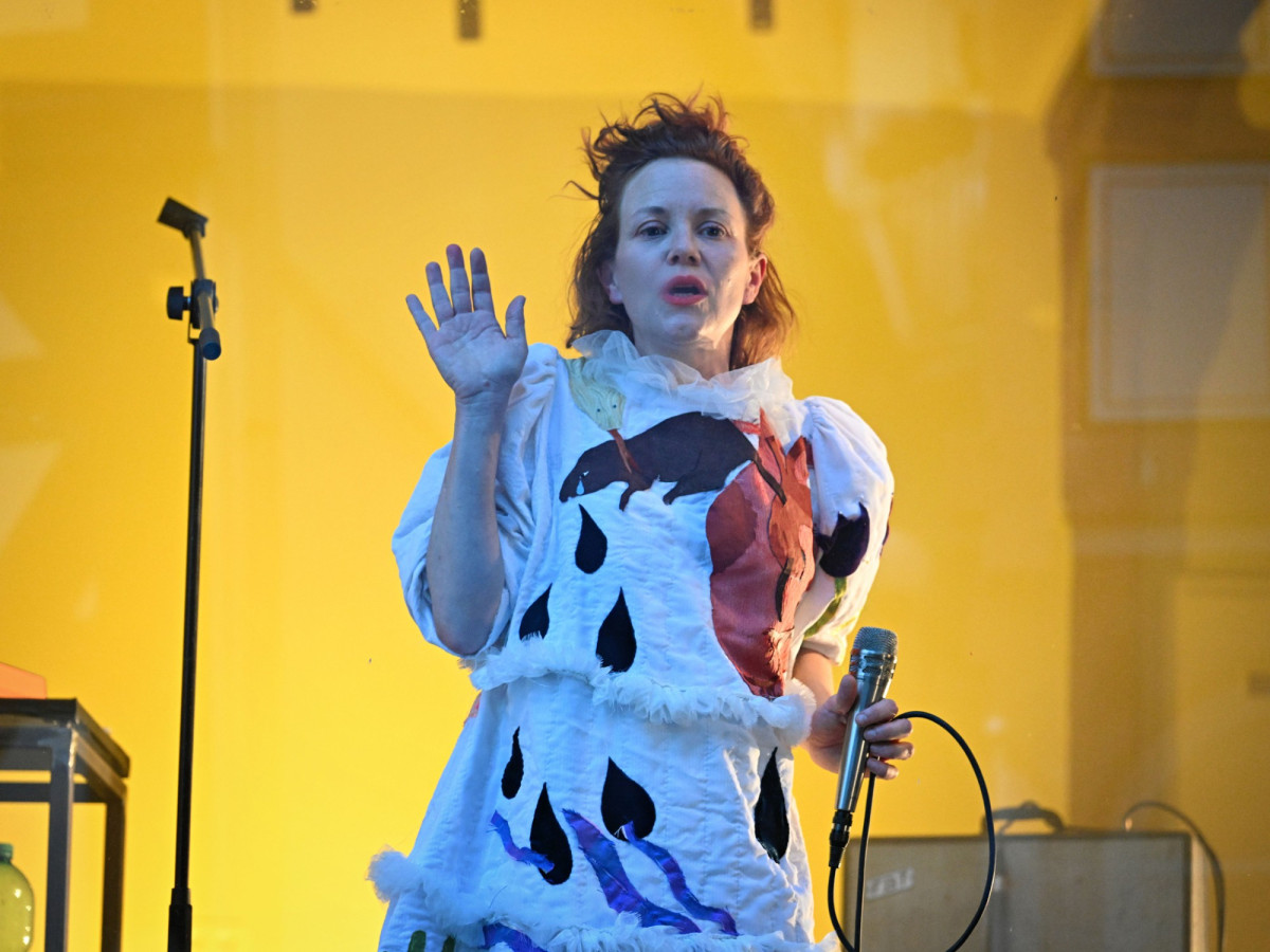 Kristin Gerwien in a tear costume bathed in yellow light